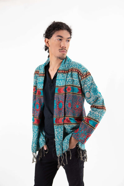 Man wearing bohemian turquoise fringe cardigan sweater with floral print.